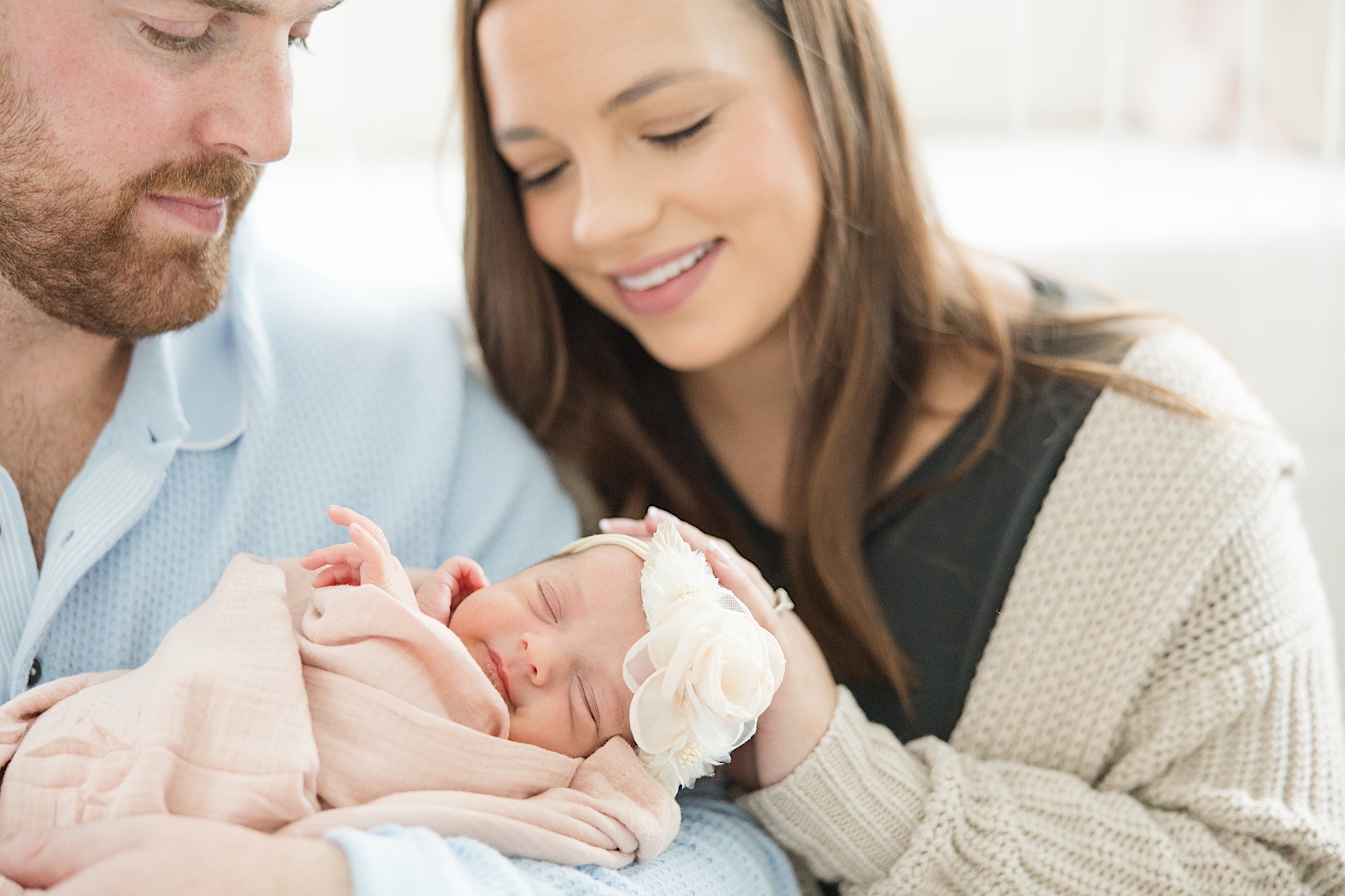 Akron Newborn Photographer Mom and Dad holding baby girl
