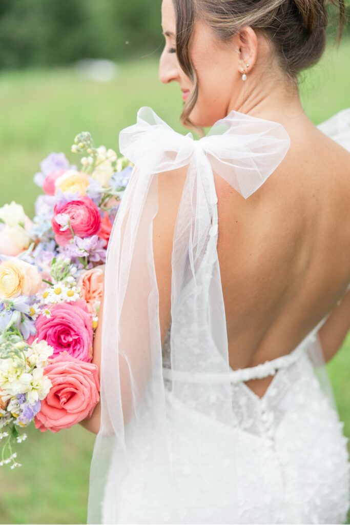 Cleveland Wedding Photographer Bride’s detailed wedding dress with illusion back and tulle bows