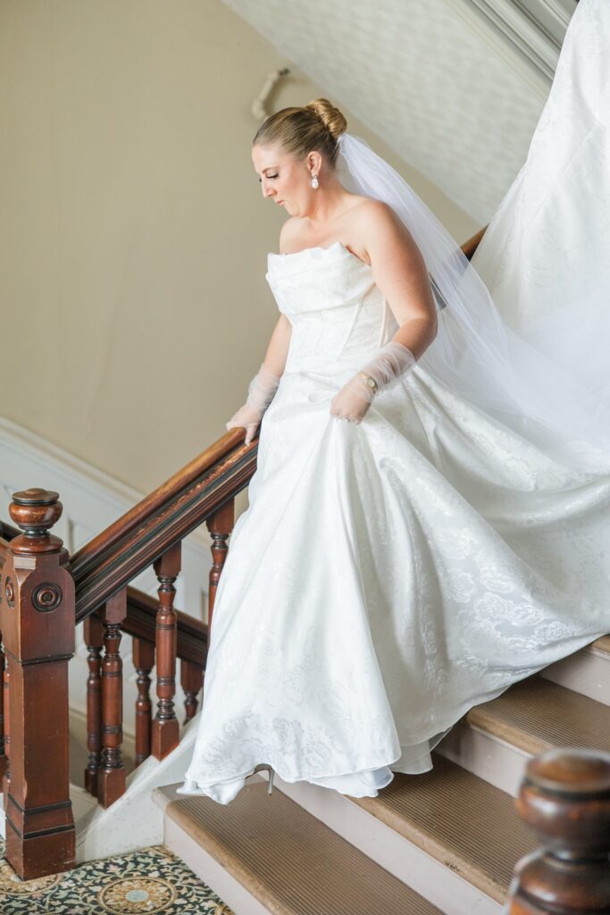 Bride descending steps Wedding at Athenaeum Hotel