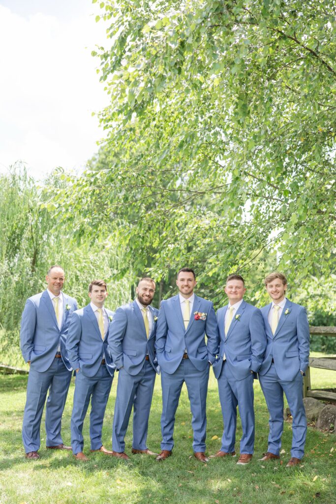 Enchanted Acres Venue Groomsmen group photo smiling 