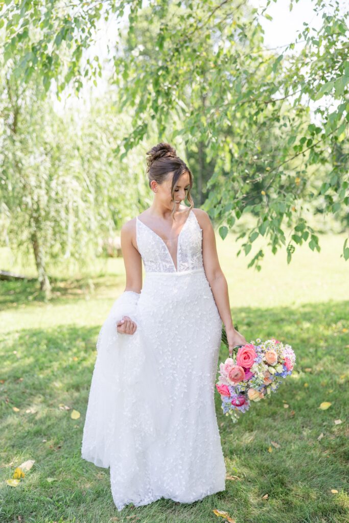 Bright and airy Cleveland Wedding Photographer summer bride holding colorful wedding bouquet