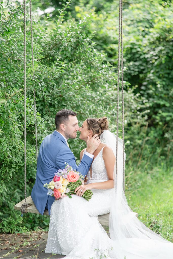 Golden Hour Cleveland Wedding Photographer portraits with soft natural light bride and groom sitting on swing together