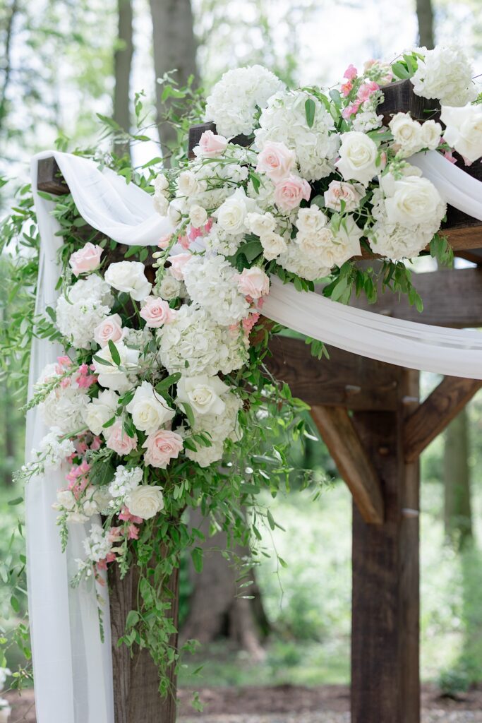 1840 Manor House Outdoor Ceremony Space with luscious spring florals by Molly Taylor & Co.