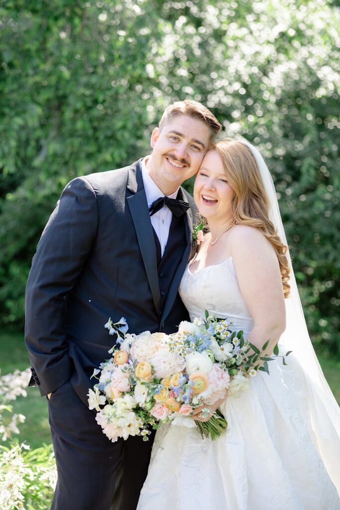 Light and Airy Akron Wedding Photographer Wildflower bouquet bride and groom smiling