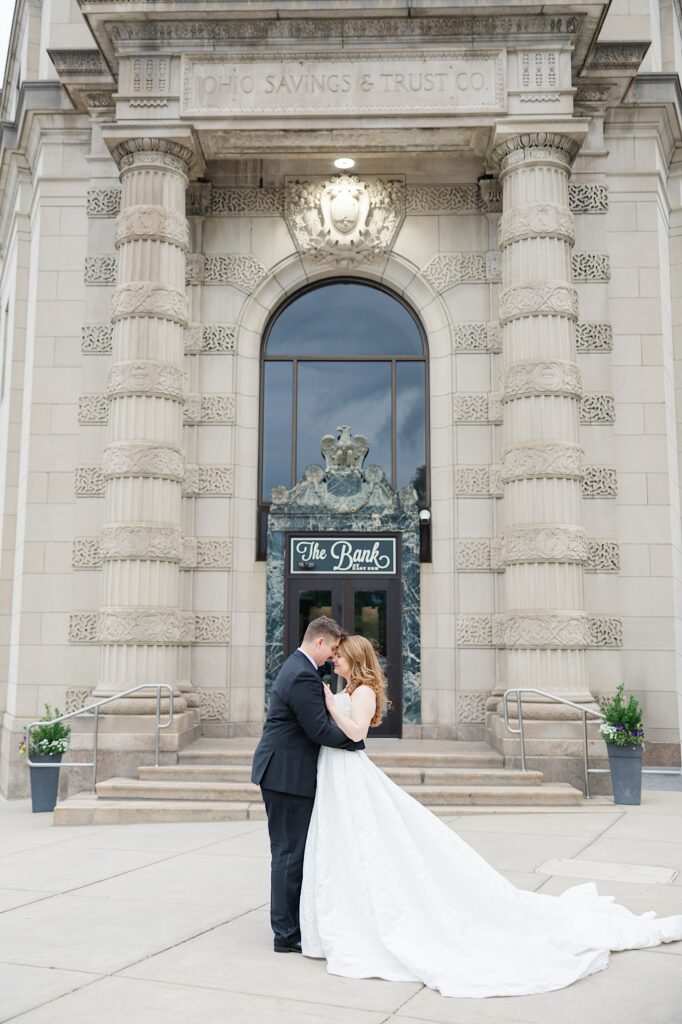 The Bank at East End wedding venue converted from the Old Goodyear Bank Bride and Groom portraits in front of the building