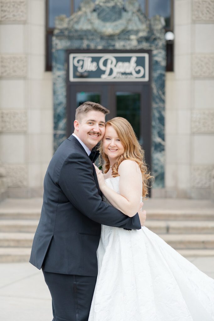 Historic Goodyear Bank wedding venue The Bank at East End Bride and Groom smiling in front of venue